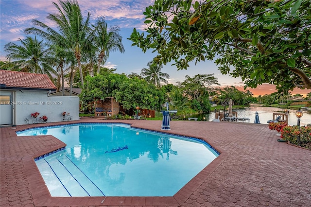 1460 NW 99th Ave, Plantation, FL 33322 - pool at dusk with an outdoor pool, a patio, and a water view