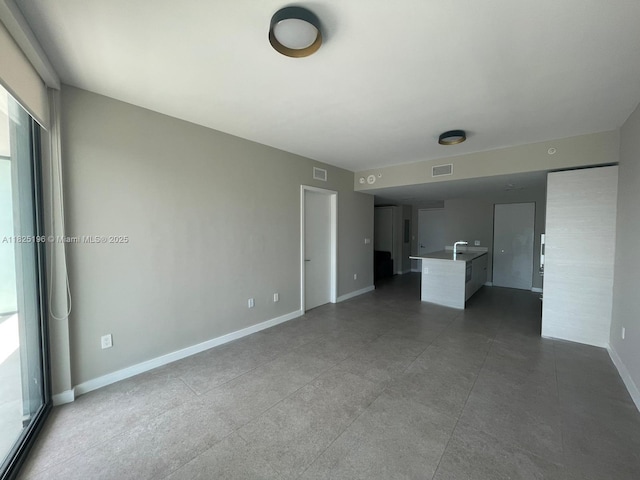 1300 S Miami Ave Unit 2304, Miami, FL 33130 - unfurnished living room featuring baseboards and a sink