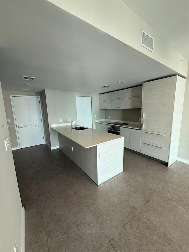 1300 S Miami Ave Unit 2304, Miami, FL 33130 - kitchen with modern cabinets, white cabinetry, and light countertops