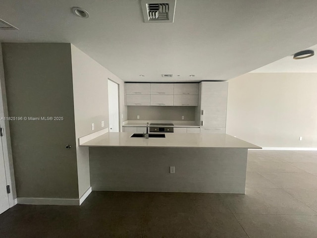 1300 S Miami Ave Unit 2304, Miami, FL 33130 - kitchen with white cabinetry, light countertops, modern cabinets, a peninsula, and recessed lighting