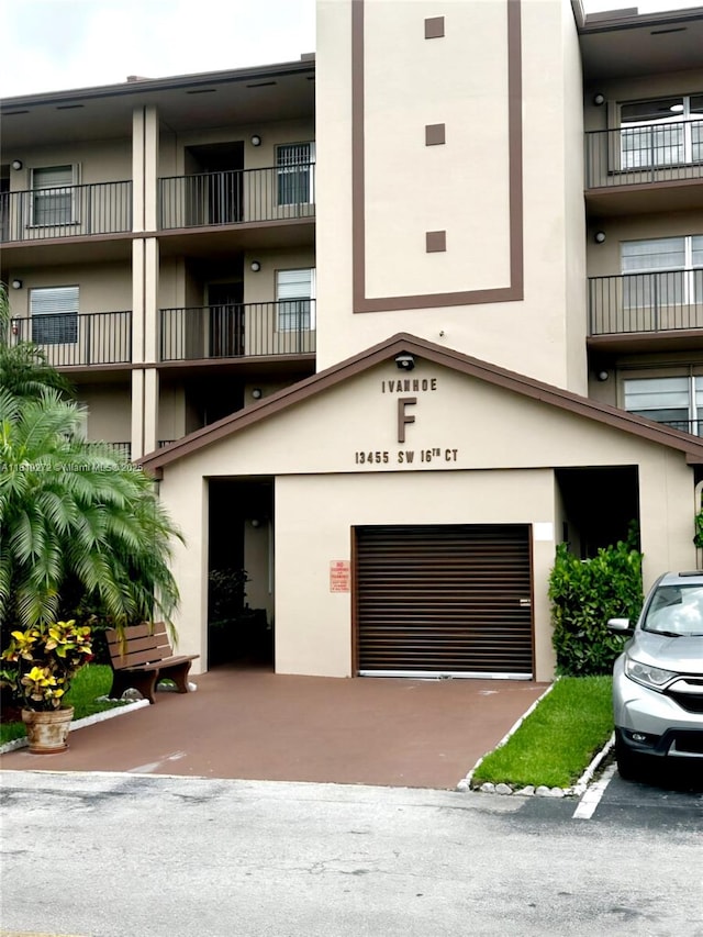 13455 SW 16th Ct Unit 304F, Pembroke Pines, FL 33027 - view of property featuring an attached garage