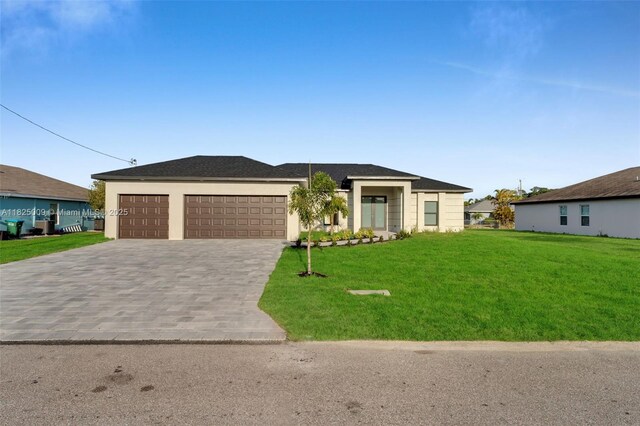 1520 NW 36th Pl, Cape Coral, FL 33993 - view of front of house with decorative driveway, a front yard, and a garage