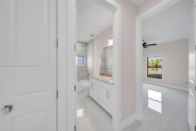 1520 NW 36th Pl, Cape Coral, FL 33993 - bathroom with vanity, healthy amount of natural light, a ceiling fan, and shower / bathtub combination
