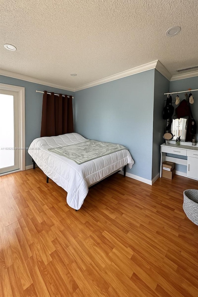359 E 46th St, Hialeah, FL 33013 - bedroom featuring crown molding, wood finished floors, and a textured ceiling