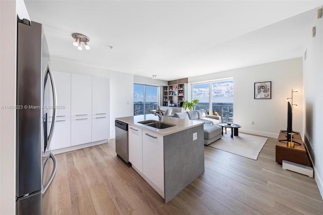 1900 N Bayshore Dr Unit 4111, Miami, FL 33132 - kitchen featuring modern cabinets, stainless steel appliances, light wood finished floors, and white cabinets