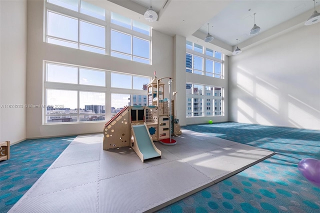 1900 N Bayshore Dr Unit 4111, Miami, FL 33132 - game room featuring carpet flooring, a city view, and a high ceiling