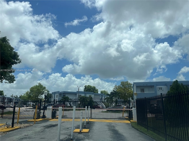 6214 SW 131st Ct Unit 103, Miami, FL 33183 - view of asphalt road with a gate, street lighting, and a gated entry