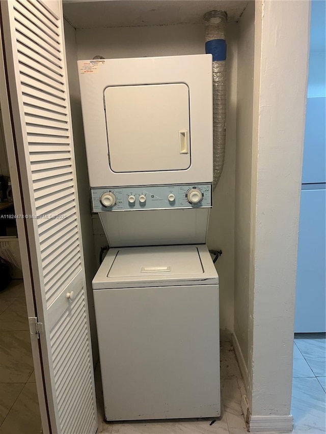6214 SW 131st Ct Unit 103, Miami, FL 33183 - washroom featuring estacked washer and dryer and light marble finish flooring