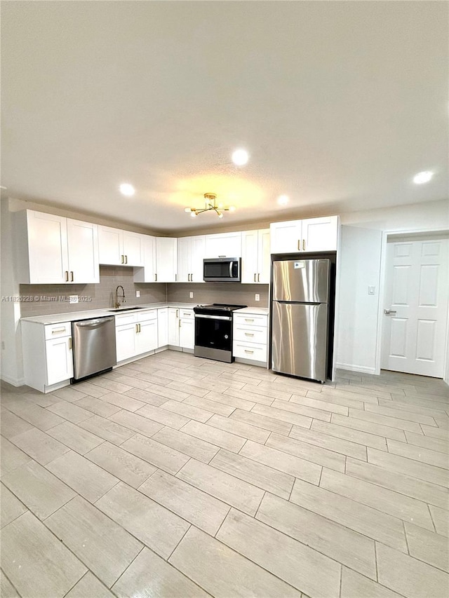 4438 E Riverside Dr, Fort Myers, FL 33905 - kitchen featuring stainless steel appliances, white cabinets, light countertops, recessed lighting, and tasteful backsplash