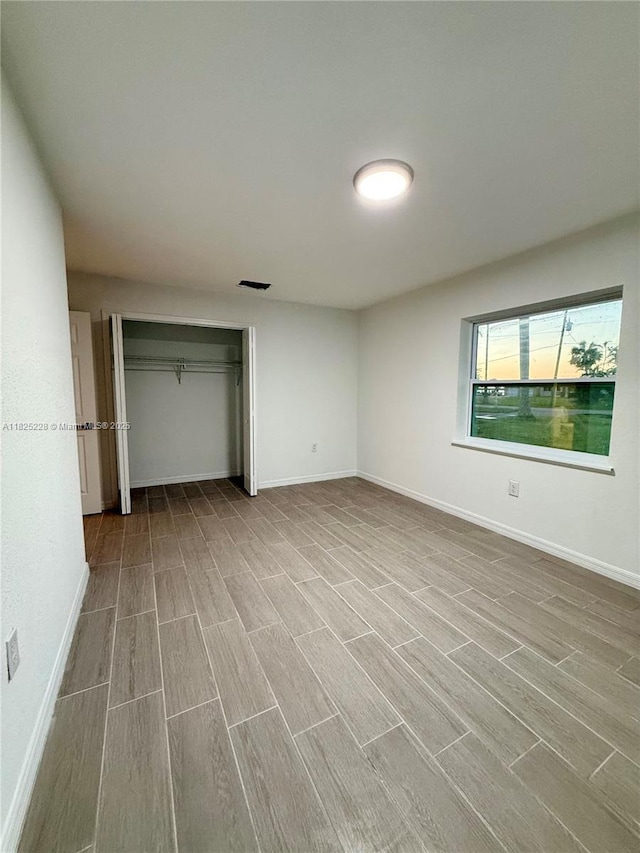 4438 E Riverside Dr, Fort Myers, FL 33905 - unfurnished bedroom featuring wood finished floors and a closet