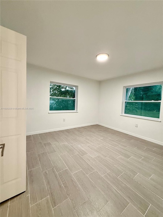 4438 E Riverside Dr, Fort Myers, FL 33905 - unfurnished room featuring wood finish floors and healthy amount of natural light