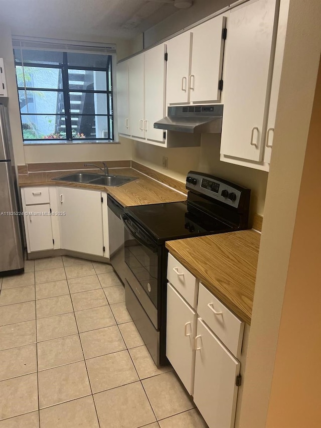 1224 S Military Trl Unit 2312, Deerfield Beach, FL 33442 - kitchen with under cabinet range hood, appliances with stainless steel finishes, white cabinets, and light tile patterned floors
