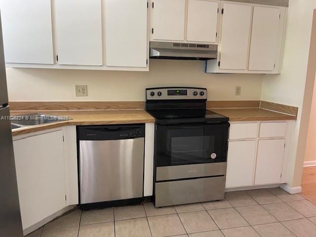1224 S Military Trl Unit 2312, Deerfield Beach, FL 33442 - kitchen featuring stainless steel appliances, under cabinet range hood, white cabinetry, and light tile patterned floors