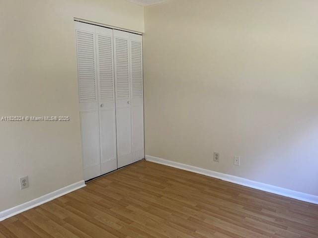 1224 S Military Trl Unit 2312, Deerfield Beach, FL 33442 - unfurnished bedroom with wood finished floors and a closet