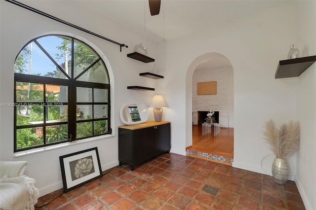 425 Cadagua Ave, Coral Gables, FL 33146 - living area with ceiling fan and a large fireplace