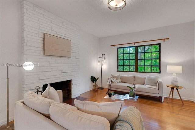 425 Cadagua Ave, Coral Gables, FL 33146 - living room featuring wood finished floors and a stone fireplace