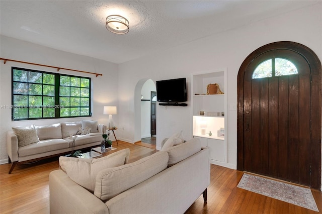 425 Cadagua Ave, Coral Gables, FL 33146 - living area featuring arched walkways and light wood-style flooring