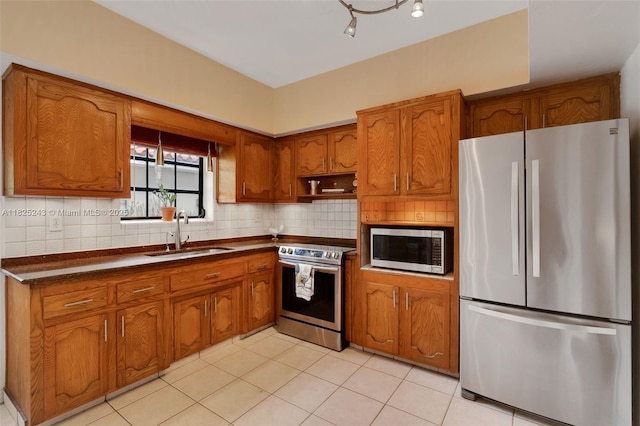 425 Cadagua Ave, Coral Gables, FL 33146 - kitchen with stainless steel appliances, brown cabinets, dark countertops, backsplash, and light tile patterned floors