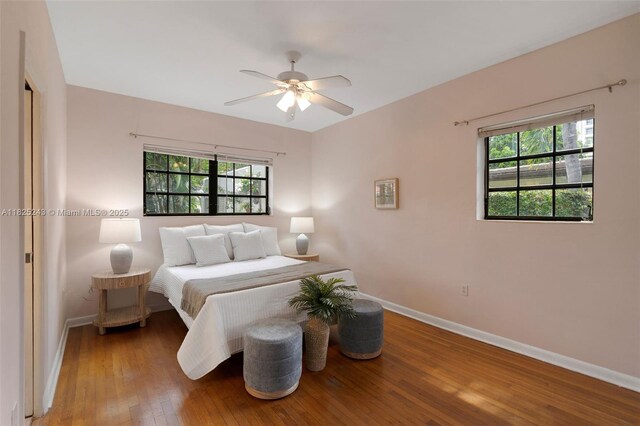 425 Cadagua Ave, Coral Gables, FL 33146 - bedroom with hardwood / wood-style flooring, multiple windows, and a ceiling fan