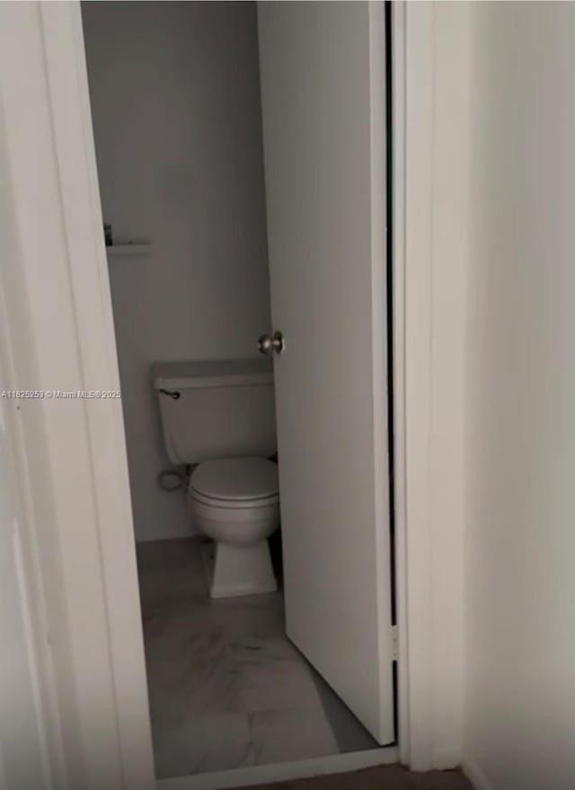 251 174th St Unit 1210, Sunny Isles Beach, FL 33160 - bathroom with toilet and marble look tiles