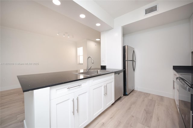 2406 Centergate Dr Unit 202, Miramar, FL 33025 - kitchen featuring appliances with stainless steel finishes, white cabinetry, light wood-style floors, a peninsula, and recessed lighting