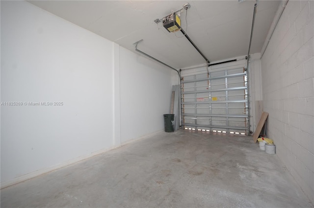 2406 Centergate Dr Unit 202, Miramar, FL 33025 - garage featuring a garage door opener and concrete block wall