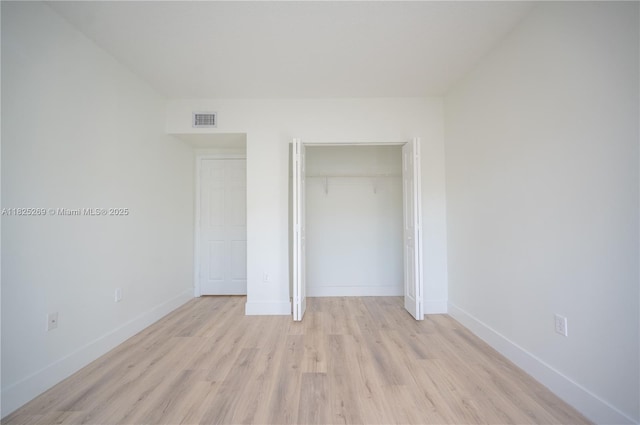 2406 Centergate Dr Unit 202, Miramar, FL 33025 - unfurnished bedroom featuring light wood-style floors and a closet