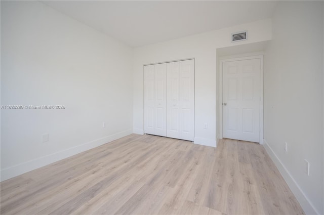 2406 Centergate Dr Unit 202, Miramar, FL 33025 - unfurnished bedroom featuring light wood-style floors and a closet