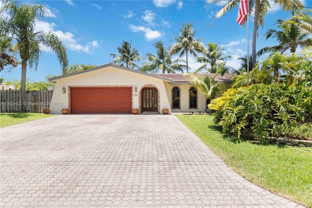 134 E Palm Dr, Margate, FL 33063 - mediterranean / spanish house with stucco siding, a garage, decorative driveway, and a tiled roof