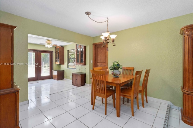 134 E Palm Dr, Margate, FL 33063 - dining space featuring a chandelier, french doors, a textured wall, and light tile patterned flooring