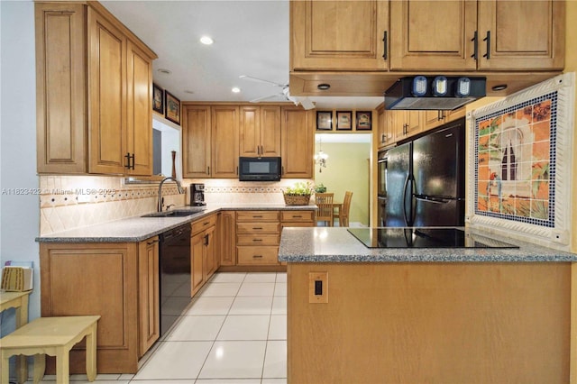 134 E Palm Dr, Margate, FL 33063 - kitchen featuring black appliances, backsplash, a peninsula, light tile patterned floors, and stone counters