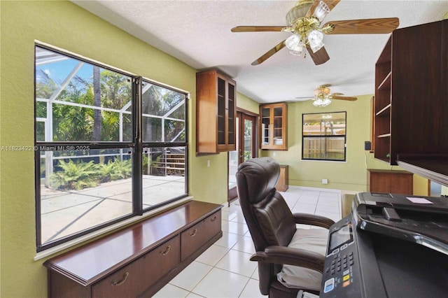 134 E Palm Dr, Margate, FL 33063 - home office featuring a textured ceiling, light tile patterned floors, ceiling fan, and a textured wall