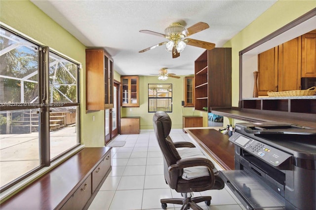 134 E Palm Dr, Margate, FL 33063 - home office featuring healthy amount of natural light, ceiling fan, light tile patterned floors, and a textured ceiling