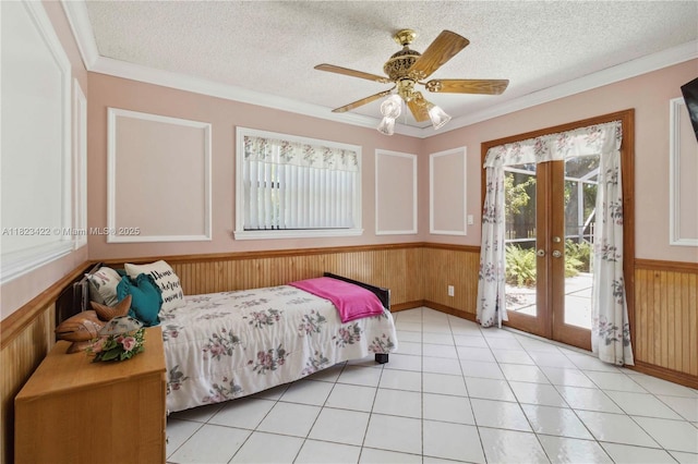 134 E Palm Dr, Margate, FL 33063 - bedroom featuring a wainscoted wall, wooden walls, french doors, access to exterior, and a textured ceiling
