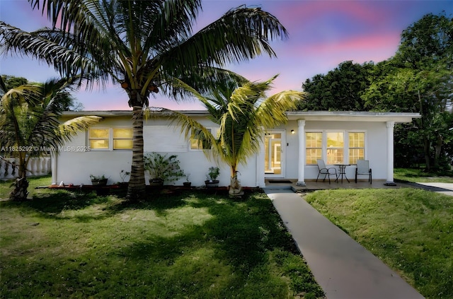 3610 NW 171st St, Miami Gardens, FL 33056 - view of front of home featuring stucco siding, a front yard, and covered porch