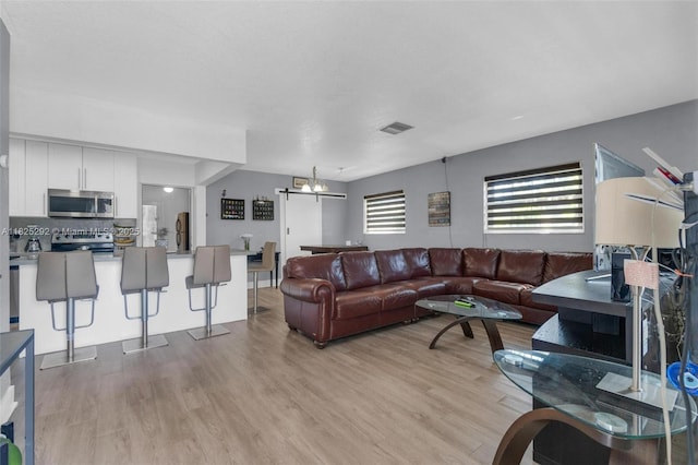3610 NW 171st St, Miami Gardens, FL 33056 - living area featuring light wood finished floors and a chandelier