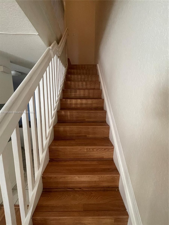 3550 Oleander Ter, Riviera Beach, FL 33404 - staircase featuring wood finished floors