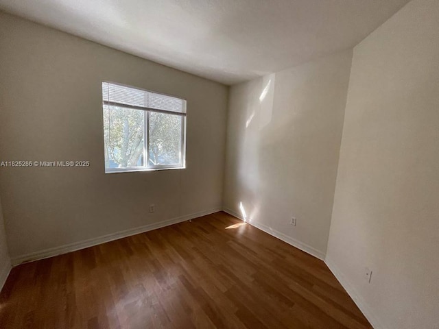 3550 Oleander Ter, Riviera Beach, FL 33404 - empty room featuring wood finished floors and baseboards