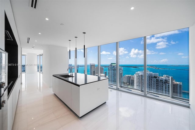 300 Biscayne Blvd Way Unit 4301, Miami, FL 33131 - kitchen featuring modern cabinets, white cabinets, a water view, hanging light fixtures, and light marble finish flooring