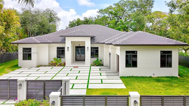 7025 SW 80th Ct, Miami, FL 33143 - rear view of property with a fenced front yard, stucco siding, and a tiled roof