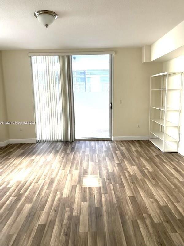 3339 Virginia St Unit 205, Miami, FL 33133 - unfurnished room featuring baseboards and wood finished floors