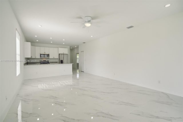 3411 62nd St W, Lehigh Acres, FL 33971 - unfurnished living room with ceiling fan, light marble finish floors, and recessed lighting