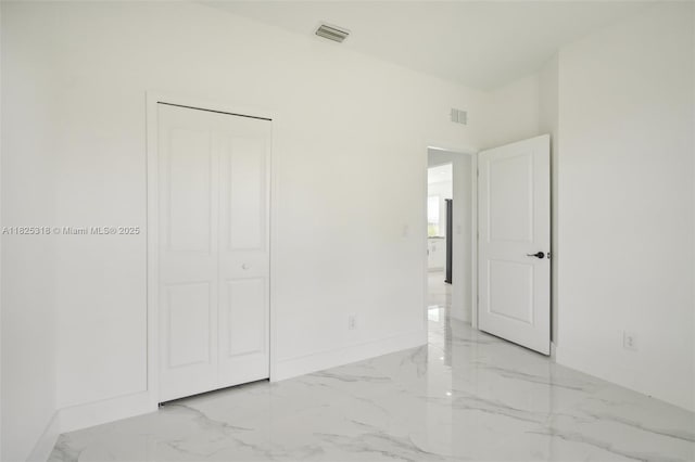 3411 62nd St W, Lehigh Acres, FL 33971 - unfurnished bedroom featuring marble tiled floors and a closet