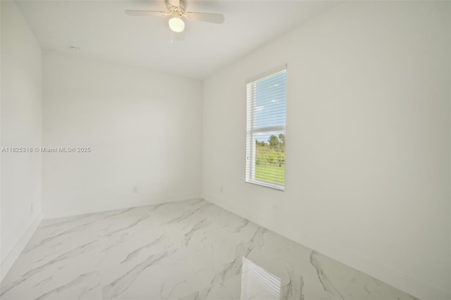 3411 62nd St W, Lehigh Acres, FL 33971 - spare room featuring healthy amount of natural light, marble finish flooring, and ceiling fan