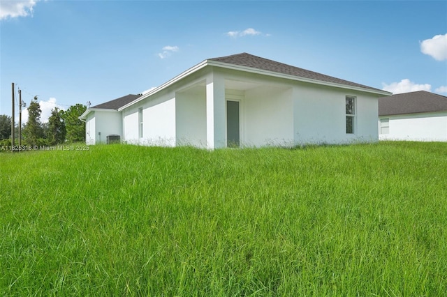 3411 62nd St W, Lehigh Acres, FL 33971 - view of home's exterior featuring stucco siding and a lawn