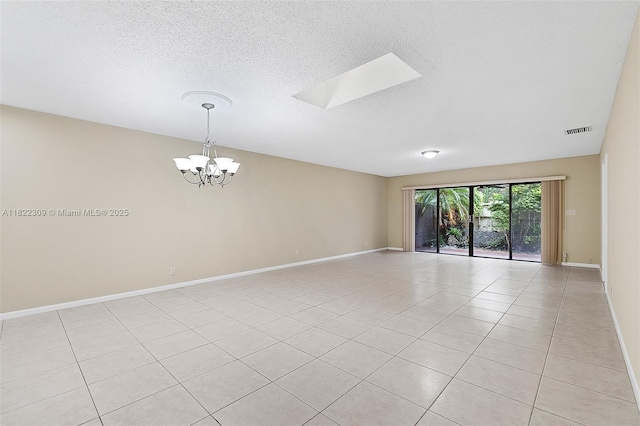 608 Saint Andrews Rd Unit 46, Hollywood, FL 33021 - unfurnished room featuring a chandelier, light tile patterned floors, and a textured ceiling
