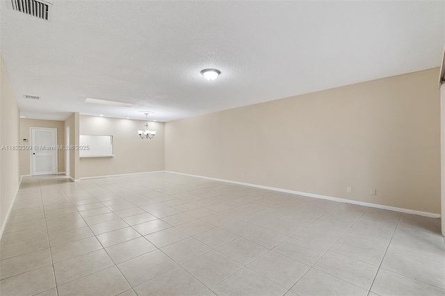 608 Saint Andrews Rd Unit 46, Hollywood, FL 33021 - unfurnished room with a textured ceiling, light tile patterned floors, and a chandelier