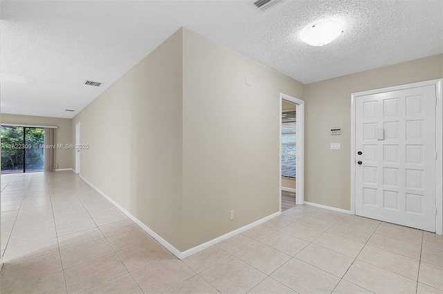 608 Saint Andrews Rd Unit 46, Hollywood, FL 33021 - foyer featuring a textured ceiling and light tile patterned floors