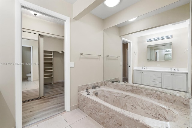 608 Saint Andrews Rd Unit 46, Hollywood, FL 33021 - bathroom with double vanity, tile patterned flooring, a bath, and a walk in closet