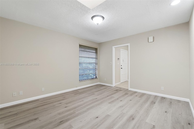 608 Saint Andrews Rd Unit 46, Hollywood, FL 33021 - spare room with light wood-style floors and a textured ceiling
